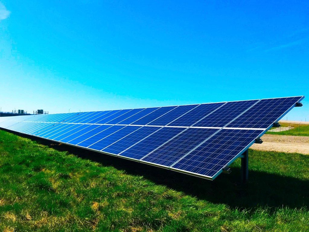 A range of solar panels set out in an open field